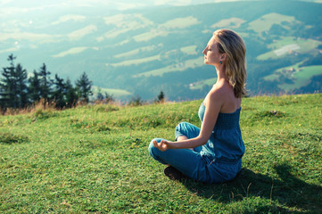 Young woman meditating outdoors