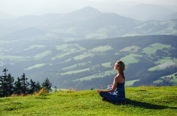 Young woman meditating outdoors