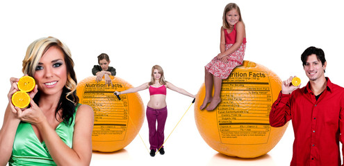 People Standing Behind Orange with Nutrition Label