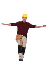 craftsman isolated on white trying to keep his balance