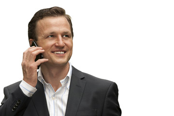 Businessman smiling while having conversation on mobile phone