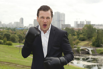 businessman in boxing gloves. ready to business to fight.