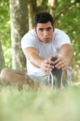 Man stretching in the forest