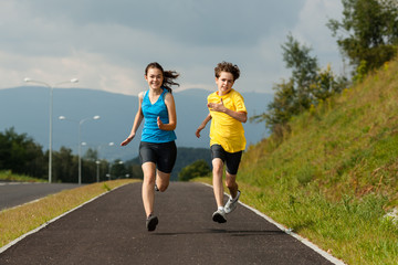 Girl and boy running, jumping outdoor