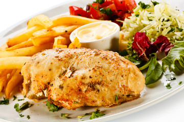 Grilled chicken breast, French fries and vegetables