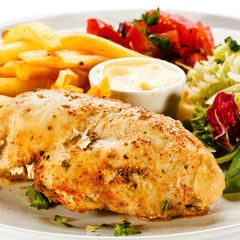 Grilled chicken breast, French fries and vegetables
