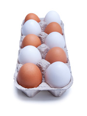 ten white and brown chicken eggs in a carton box, isolated