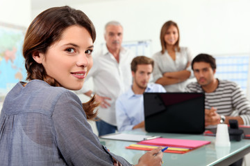 Students gathered around laptop in class