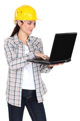 Female builder stood with laptop