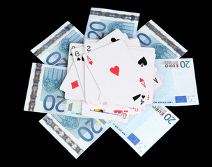 Euro and a deck of playing cards isolated on black