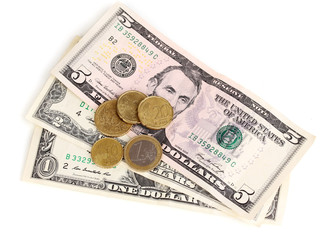 Dollar bills and coins isolated on white