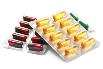 Capsules packed in blisters, isolated on white