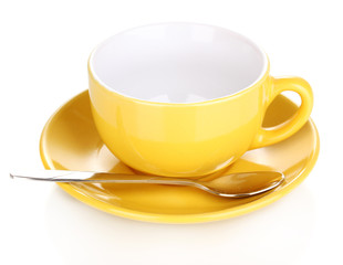 Yellow cup and saucer isolated on white