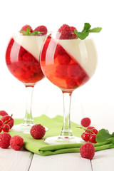 fruit jelly with berries in glasses on wooden table
