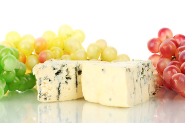 Cheese with mold and grapes on white background close-up