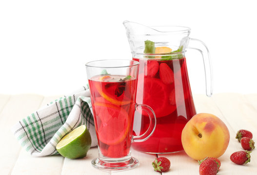 sangria in jar and glass with fruits,