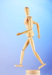 wooden mannequin, on blue background