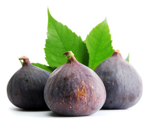 Ripe sweet figs with leaves isolated on white