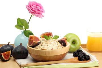 tasty oatmeal with fruits glass of juice, on wooden table