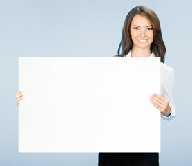 Businesswoman showing signboard, over blue