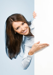 Businesswoman showing signboard, over blue