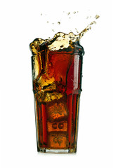 Splashing cola in glass. Isolated on white background