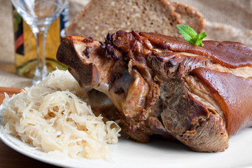 German food specialty - roasted pork knuckle with sauerkraut