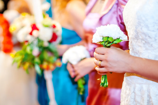 Brides Maids Holding Flower Bouquets At Wedding Ceremony