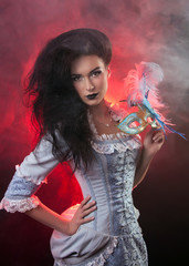 Beautiful Halloween vampire woman aristocrat with venetian mask