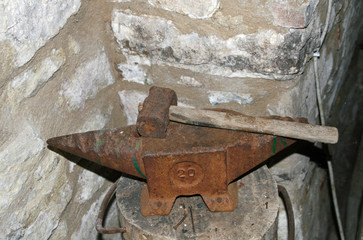 old and rusted iron anvil for beating