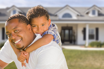 Obraz premium Mixed Race Father and Son In Front of House
