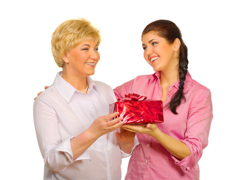 Senior Woman Giving Gift To Her Daughter