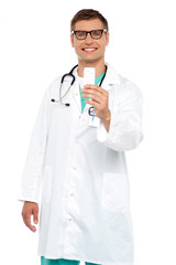 Smiling doctor showing tablets pack to camera