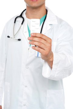Cropped image of physician displaying medicine pack