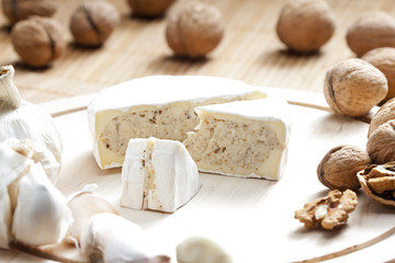 cheese brie filled with cheese mixture of chopped walnuts and ga