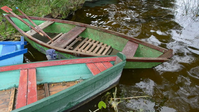 old wooden summer boats on lake water