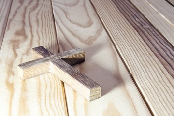 cross on wood table background