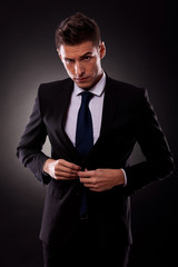 businessman buttoning jacket, getting dressed