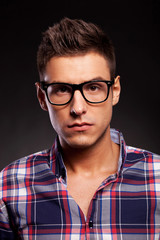 handsome young casual man looking into the camera