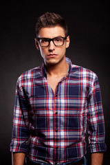 young man looking very seriously at the camera