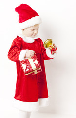 little girl as Santa Claus with a bell and Christmas present