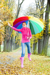 woman with an umbrella in autumnal alley