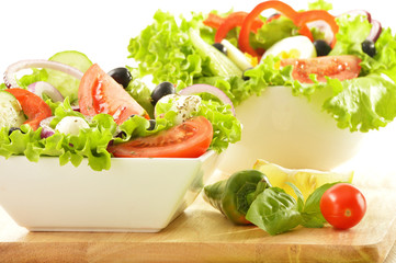 Vegetable salad bowls isolated on white