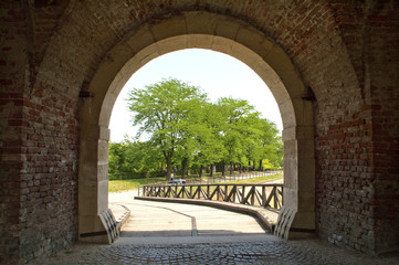 Dark corridor with a arch opening to a beautiful bridge