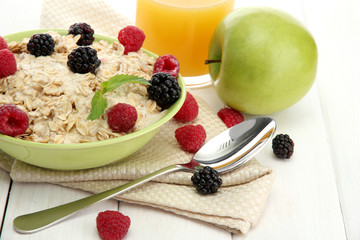 tasty oatmeal with berries and glass of juice,
