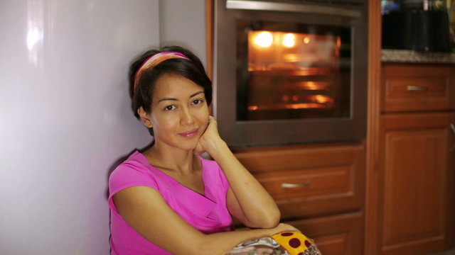 woman waiting for food in kitchen
