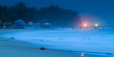 Hainan beach with long pier early in the morning.