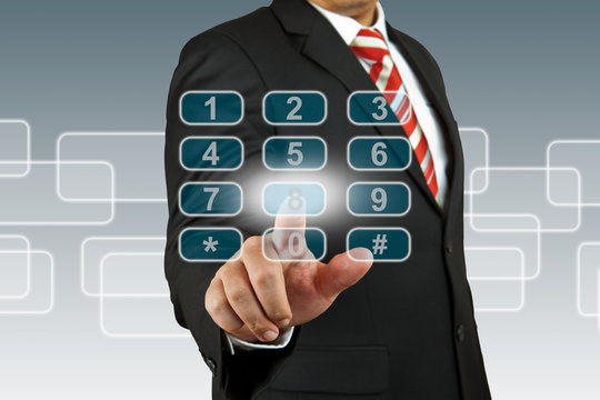 businessman hand pushing number pad screen