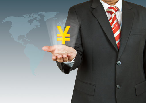 Businessman with Yen symbol over his hand