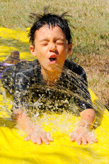 Boy Splashing on Water Slide